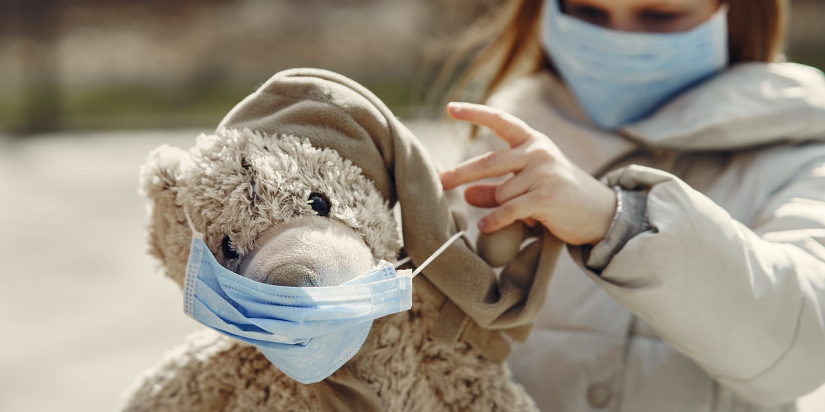 little girl with bear wearing masks 